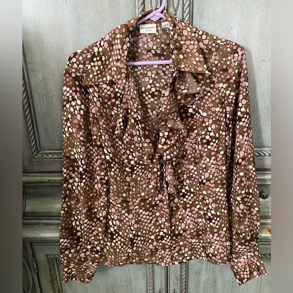 Long sleeve polka dot blouse with v-neck and ruffle.